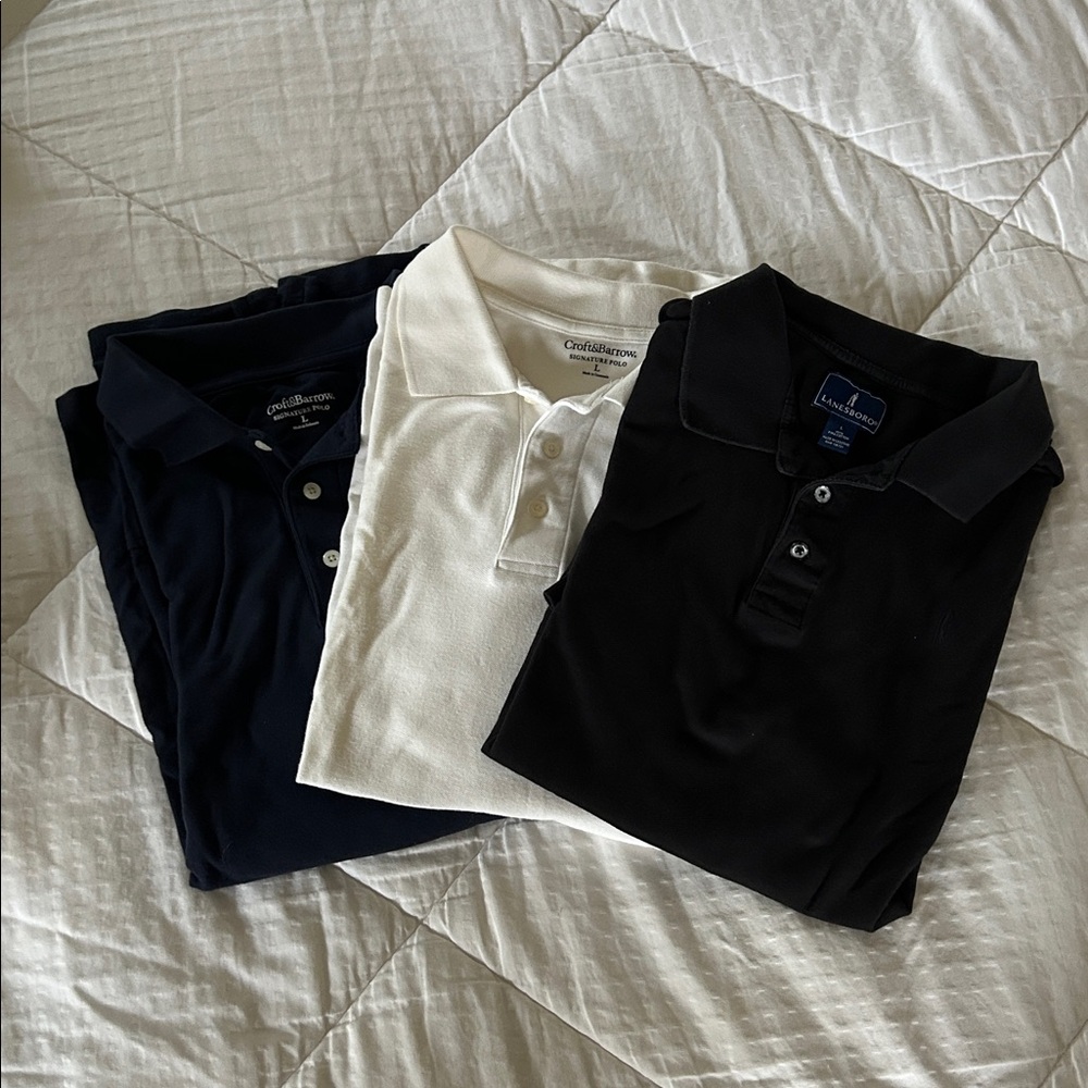 3 Classic short-sleeve cotton polo shirts. Men’s Large. Navy, white, and black.